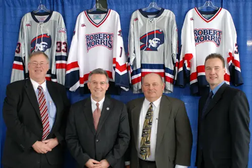 Dr. Craig Coleman - RMU Athletic Director, Dr. Greg Dell'Omo - RMU President, Bob DeGregorio - AHA Commissioner, Derek Schooley - RMU coach