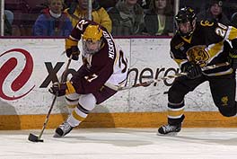 Minnesota's Aaron Miskovich (left) tries to stickhandle away from CC defenseman Tom Preissing in the Gophers' 4-1 win Saturday.