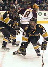 Tigers Mike Colgan (4) and Jason Jozsa (6) battle Gopher Johnny Pohl (9).