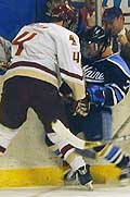 BC's Brooks Orpik (left) fights along the boards with Maine's Don Richardson.