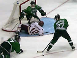 Roche (7) upends Boston College's Brian Gionta in North Dakota's 3-2 OT loss in Saturday's title game.