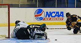 UND goalie Karl Goehring sprawls to make a save against Trent Clark.