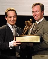 Rocky Reeves accepts the 2002 Hockey Humanitarian Award from [nl]Notre Dame coach Dave Poulin. (Photos by Pedro Cancel)