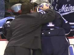 Maine assistant Matt Thomas consoles Matt Yeats (photo: Jason Waldowski)