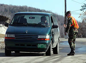 Norwich Cadet James Urso checks incoming vehicles prior to Friday's semifinal game. (Photo by Ed Trefzger)