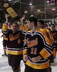 Chris Fuss holds the trophy while the Boudreau brothers, Ed (front) and Mike look on. (Photo: Ed Trefzger)