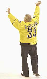 Williams, stepping down after 33 years as Michigan's PA announcer, acknowledges the crowd.