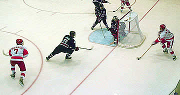 Behind the net, John Laliberte feeds David Van der Gulik (7), setting up BU's third goal.