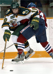 Clarkson's Mike Sullivan try's to get the loose puck despite the efforts UMass Lowell's Justin Coutu  (Photo: Christopher Lenney)