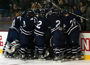 Middlebury mobs Levi Doria after he scores the game winner. (Photo by Russell Jaslow)