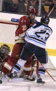 DU captain and defenseman Ryan Caldwell fends off Jon Jankus in front of the net (photo: Pedro Cancel).