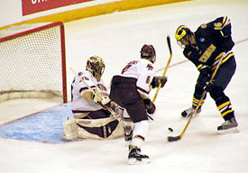 Matti Kaltiainen stops Michigan's David Rohlfs on the doorstep in the first period.