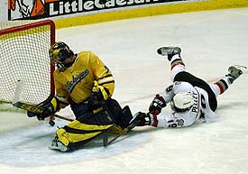 OSU's Rod Pelley (r.) scores last season against Al Montoya (photo: Christopher Brian Dudek).