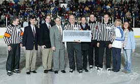 Bill Stewart stands with ECAC officials, family and fellow referees during a pre-game ceremony before his last game. (photos: Brian Beard)