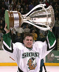 North Dakota's Zach Parise hoists the McNaughton Cup as the Sioux clinched the WCHA regular-season title. (photo: Patrick C. Miller)