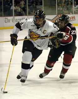 CC captain Mark Stuart (here trailed by SCSU defenseman Matt Stephenson) helped bring the Tigers back from the brink (photo: Casey Gibson).