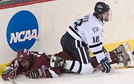 UNH's Justin Aikins gets the better of Crimson Tyler Magura along the boards (photo: Melissa Wade).