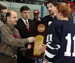 Middlebury's John Dawson and Kevin Cooper (11) accept the national championship trophy from Vince Eruzione (left) and Dan Stauber. (photo by Ed Trefzger)