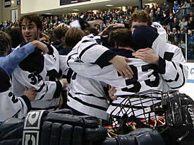 Captain Brian Phinney (33) hugs teammates as Samuel Driver (38) looks on.