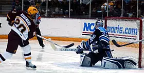 Evan Kaufmann beats Jimmy Howard for the overtime winner Saturday (photos: Jason Waldowski).