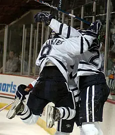 Jacob Micflikier (l.) celebrates Daniel Winnik's OT goal with Winnik (r.) and Chris Murray (photo: Josh Gibney).