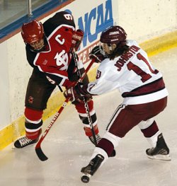 Katie Johnston (11) battles with Saints captain Rebecca Russell.