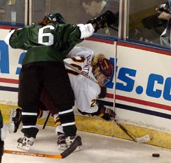 Dartmouth's Katie Weatherston cross-checks Minnesota's Natalie Darwitz into the boards.