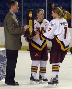 Krissy Wendell eagerly awaits to receive the championship trophy from Kelly Stephens and NCAA Committee Chair Steve Metcalf.