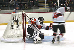 George Eliopoulos makes one of 29 saves for RIT. (photos by Russell Jaslow)