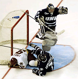 UNH goaltender Jeff Pietrasiak leaps to avoid BC's Patrick Eaves (9) and teammate Tyson Teplitsky. (photos: Josh Gibney)