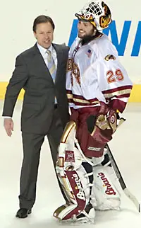 Pioneers coach George Gwozdecky celebrates the DU win with goaltender Peter Mannino (photo: Melissa Wade).