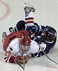 Sean Collins (r.) and Matt Carle both go down here, but after Sunday's results, Hockey East's season is done while the WCHA plays on (photo: Melissa Wade).