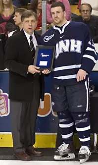 Defenseman Brian Yandle (with Hockey East commissioner Joe Bertagna) may earn more hardware this season (photo: Melissa Wade).