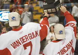 BU senior co-captains David Van der Gulik (MVP) and Brad Zancanaro raise the Lamoriello trophy to their fans (photos: Melissa Wade).