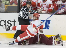 Brandon Yip and Joe Rooney go down next to linesman Bob Bernard.