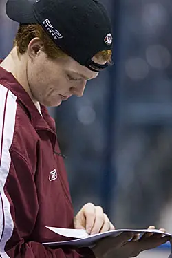 BC netminder Cory Schneider with some light reading during Friday's practice (photo: Melissa Wade).