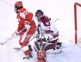 BU's Jason Lawrence scores against Crimson netminder John Daigneau (photos: Melissa Wade).