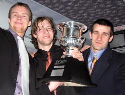 Raider assistant captains Liam Huculak (l.) and Kyle Wilson and team captain Jon Smyth celebrate with the Cleary Cup, shared by Colgate... (photo: Colgate sports information)