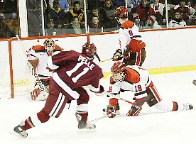 Jon Pelle takes a Crimson shot on goal against Justin Pesony. Defending for SLU are Jamie Parker (18) and Jared Ross (8).