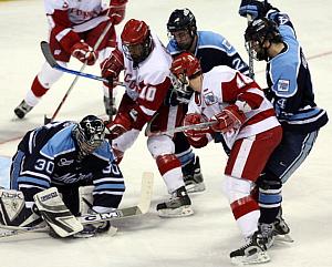 Maine's Ben Bishop makes a save Thursday, as UW's Robbie Earl and Adam Burish invade his crease despite Travis Ramsey and Steve Mullin's efforts (photo: Melissa Wade).