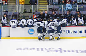 Middlebury uses a TV timeout to discuss strategy ... or perhaps to share a joke. (photo: Angelo Lisuzzo)