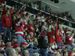 Wisconsin fans at the Green Bay men's regional react to the announcement of the women's NCAA title victory. (Photo: Ryan Coleman)