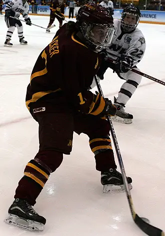 Junior forward Becky Wacker handles the puck in the Gophers' win over UNH Friday (Photo: Ryan Coleman)