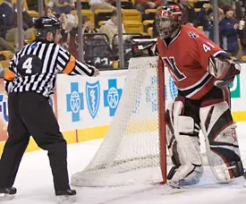 NU netminder Adam Geragosian objects to the Crimson's third goal of the game.