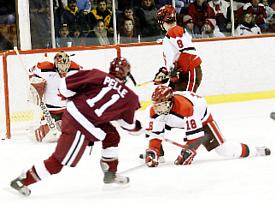 Harvard's Jon Pelle shoots on SLU netminder Justin Pesony earlier this season. Pesony is the reigning ECACHL goaltender of the week (photo: Lowell Chow).