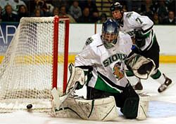 Fighting Sioux netminder Jordan Parise turns aside a shot (photo: Skip Strandberg).