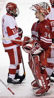 Chris Higgins (l.) shakes hands with UNO netminder Jerad Kaufmann in the wake of Higgins' hat trick and BU's 9-2 win (photo: Melissa Wade).