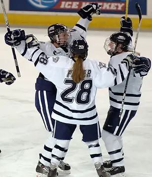Martine Garland (L) is congratulated by Sam Faber and Sadie Wright-Ward after scoring UNH's second goal. (Photo: Josh Gibney)