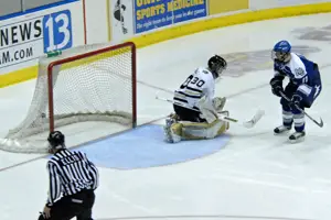 Air Force's Josh Frider bangs home a rebound past Josh Kassel for his second goal of the game.