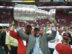 Former Norwich player Keith Aucoin hoists the cup.